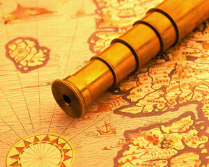 ca. 2000 --- Spyglass on a Map --- Image by © Royalty-Free/Corbis